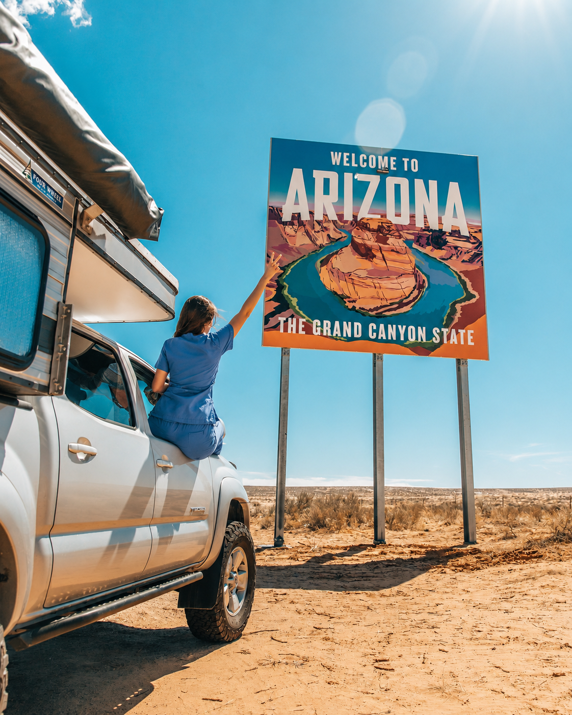 Traveler reaching toward a Welcome to Arizona state sign in the desert